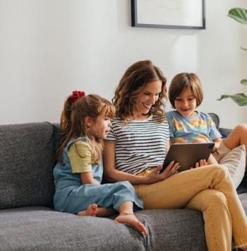 A happy family in Jenison enjoying screen time in their living room after Furnace service.