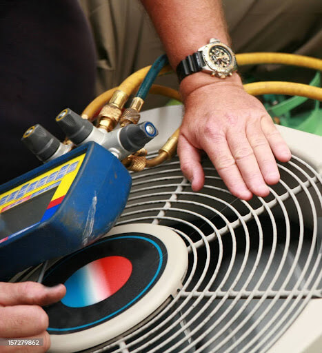 Mast Heating & Cooling technician completing AC maintenance check in Zeeland